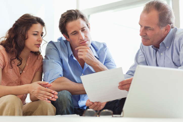 Couple going over paperwork with financial advisor